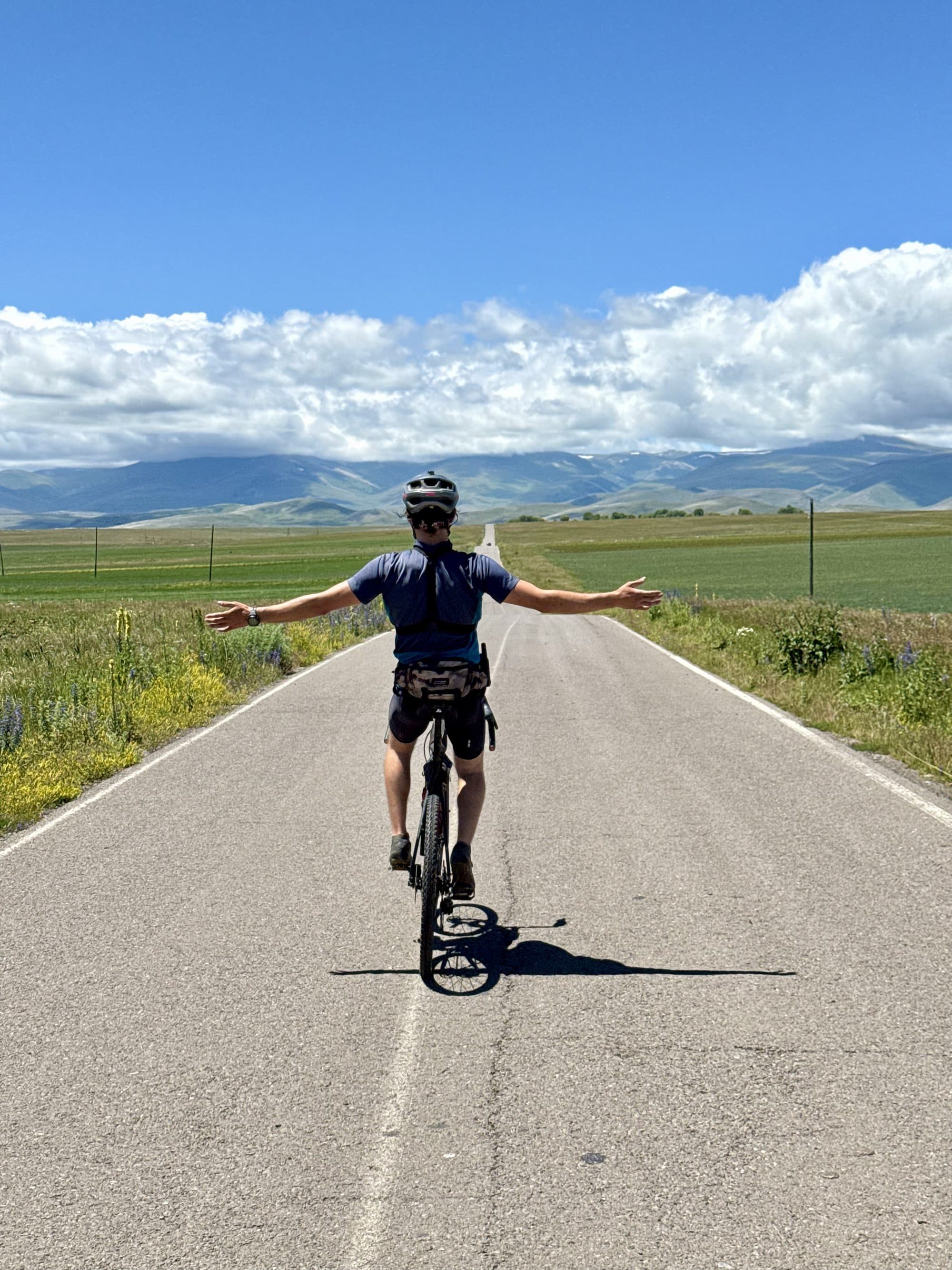 A rider on the empty open road across the Javakheti volcanic plateau