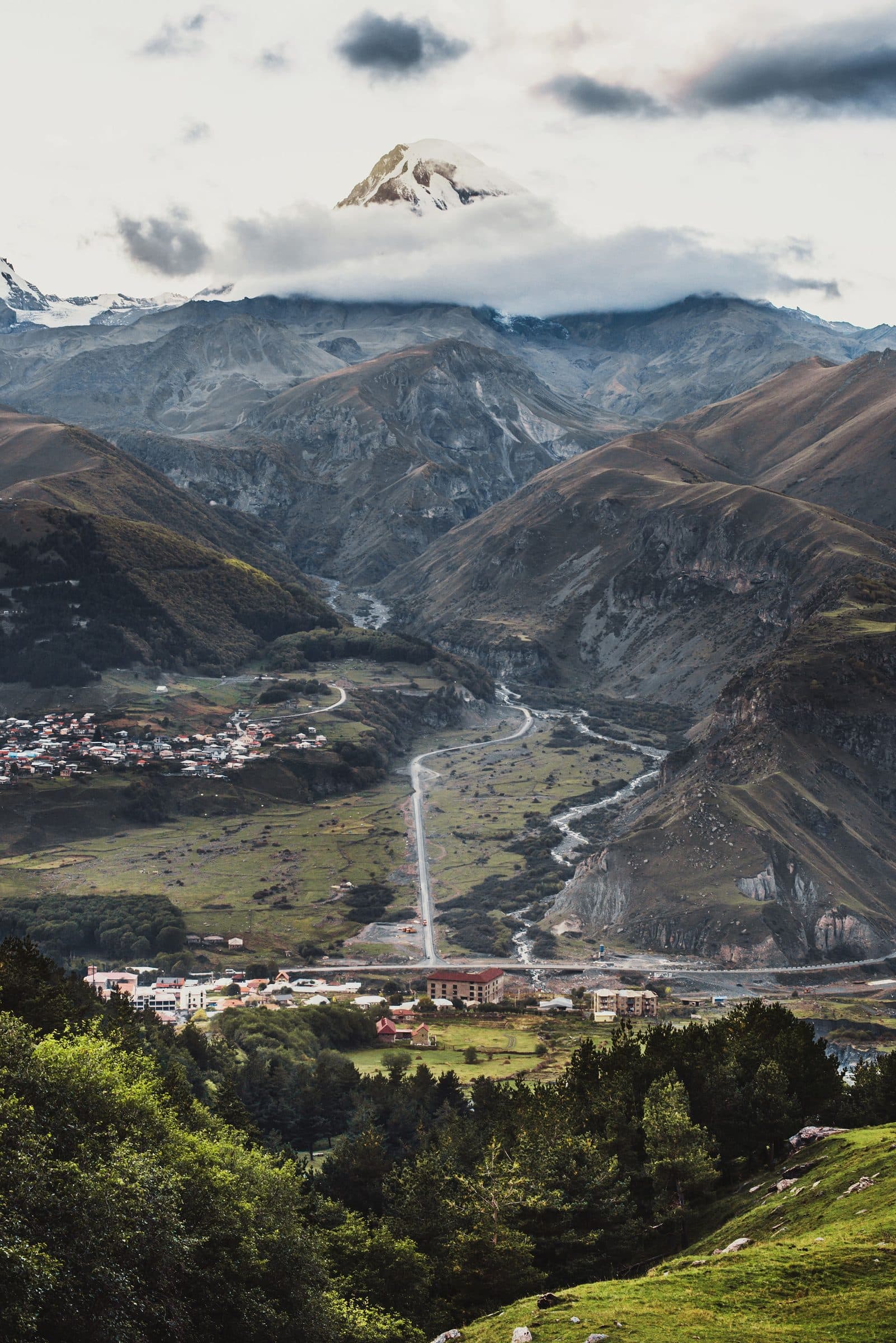 Mount Kazbek wrapped in cloud above the Stepantsminda valley