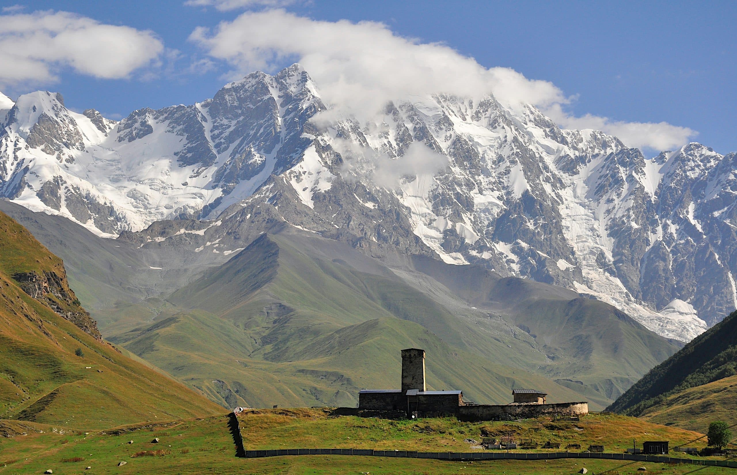 Ushguli's Lamaria tower and church under the wall of Mount Shkhara