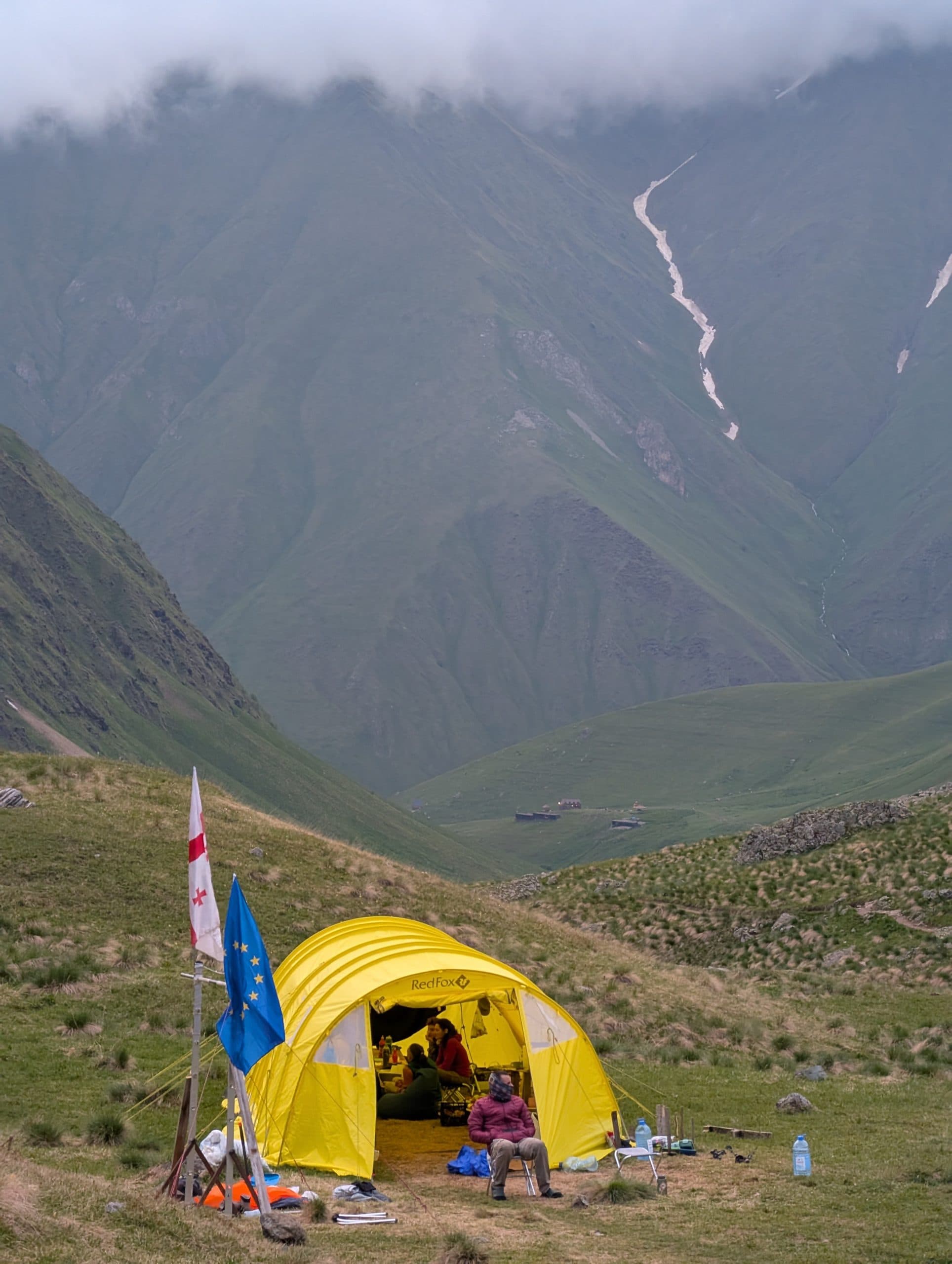 Alpine base camp with the dining tent beneath the Chaukhi peaks
